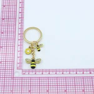 Gold tone alloy bee keychain with rhinestones and flower pendant cute bag charm accessory