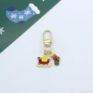 Detailed view of the Christmas alloy enamel keychain featuring a cute sleigh and stocking pendant.