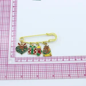 Christmas alloy brooch with cute enamel charms including reindeer gift box and stocking for festive wear.