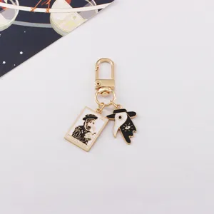 Detailed close-up shot of punk style plague doctor enamel keychain with tarot card pendant.