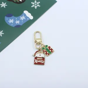 Cute Christmas keychain featuring Santa and gift box charm, alloy drip oil bag accessory.