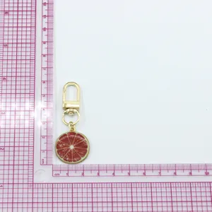 Alloy grapefruit fruit slice keychain charm pendant for keys bags airpods accessories detail view