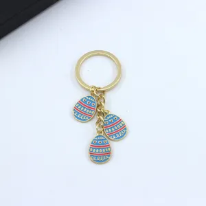 Cute Easter egg keychain with enamel blue charms, stylish metal keyring for women bag decor.