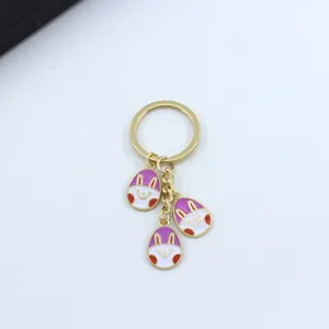 Easter bunny ear painted egg keychain detail, cute metal pendant for women keys decoration.
