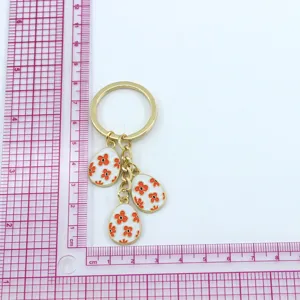 Easter egg keychain detailed view, featuring cute floral patterned egg pendants on a gold ring.