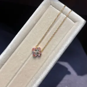 Elegant four-leaf clover pendant necklace with pink zirconia and delicate gold chain for women.