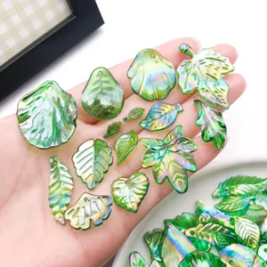 Detail shot of assorted green acrylic leaf charms with AB iridescent finish for DIY jewelry.