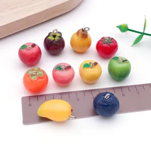 Mini resin fruit charms detail shot showing cute apple and pear pendants for DIY jewelry making.