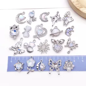 Silver alloy charm pendants with sparkling rhinestones and opal for DIY jewelry making.