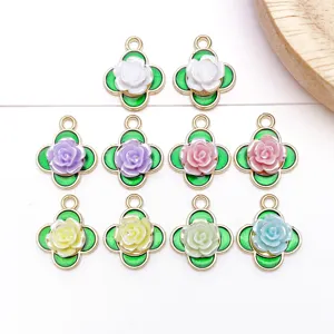Close-up of colorful enamel clover rose charms, delicate DIY jewelry pendant accessories.