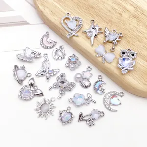 Detailed shot of various silver-plated DIY charms, featuring sparkling white zircon and crystal.