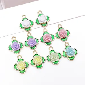 Detailed view of colorful enamel rose flower clover alloy charms for DIY jewelry making.