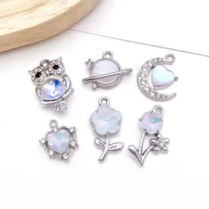 Close-up detail of silver DIY jewelry charms with sparkling zircon, perfect for handmade craft.