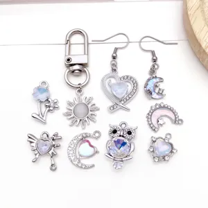 Silver tone alloy DIY jewelry charms set including sun, owl and moon pendants for use.