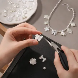 Close-up detail of diy handmade imitation pearl charm jewelry accessories, flower and butterfly.