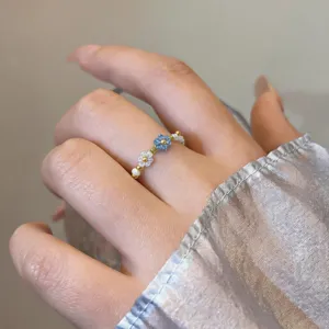 Elegant handmade beaded flower ring with blue and white crystals, charming daily jewelry accessory.