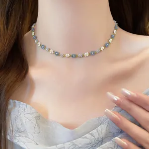 Close-up detail of colorful beaded flower choker necklace, elegant floral jewelry accessory.