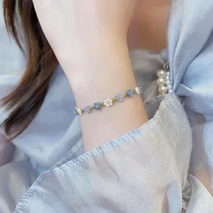 Delicate crystal beaded flower bracelet detail shot showcasing vibrant colorful floral charm.