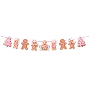 Close up of cute pink gingerbread man and christmas tree banner string for holiday party.