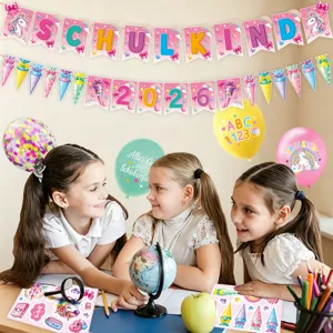 Detailed view of back to school party decorations, unicorn banners, balloons and stickers.