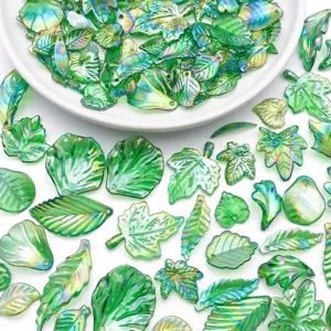 Close-up detail showing various green AB iridescent acrylic leaf beads for DIY handmade jewelry earrings.