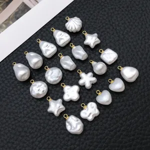Baroque irregular white pearl pendants set with gold loops, perfect for DIY jewelry making.