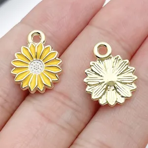 Close-up detail shot of metal sunflower daisy charms with yellow enamel DIY jewelry parts.