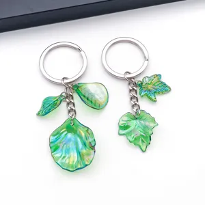 Close-up detail of green iridescent acrylic leaf keychain charm, versatile DIY craft accessory.