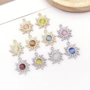 Close-up of zinc alloy sun pendants inlaid with colorful cat eye stones for DIY crafts.