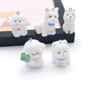 Close-up of cute white flocked animal charms with metal loops, perfect for DIY jewelry and crafts.