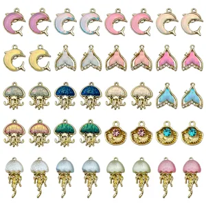 Close-up of assorted alloy rhinestone dolphin and jellyfish charms for DIY jewelry making.