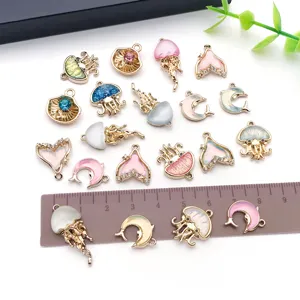 Detailed view of colorful rhinestone enamel jellyfish fish tail charms DIY jewelry making.