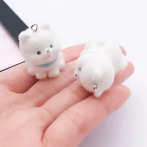 Close up of cute white fluffy puppy charms with metal rings, perfect for DIY phone chains and keychains.