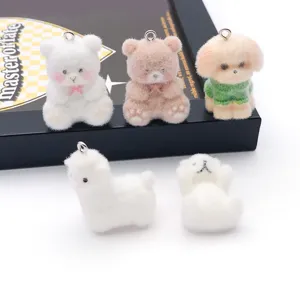 Close-up of cute flocked resin animal charms, mini bear and dog pendants for DIY keychains.