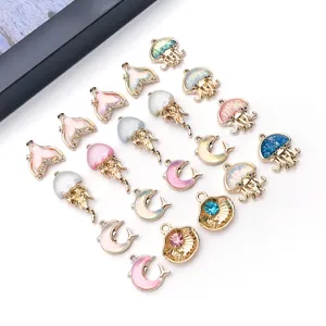 Close-up of colorful rhinestone jelly fish and dolphin tail DIY charms for handmade jewelry making.