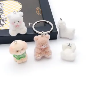 Detailed close-up view of cute flocked resin animal pendants and keychains with soft texture.