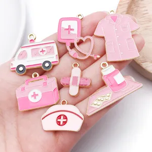 Detail view of pink medical theme enamel charms set, cute nurse alloy pendants for diy jewelry crafting.