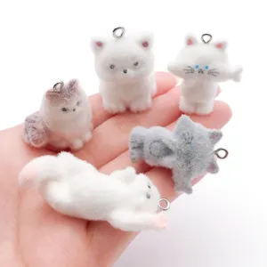 Close-up detail of cute flocking cat keychains, resin 3D animal pendant with metal ring.