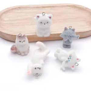 Cute flocked resin cat keychain pendant detail showcasing various adorable poses and fluffy texture.
