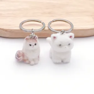 Cute resin flocked cat keychain pair, lovely animal bag charm and car key ring accessory.