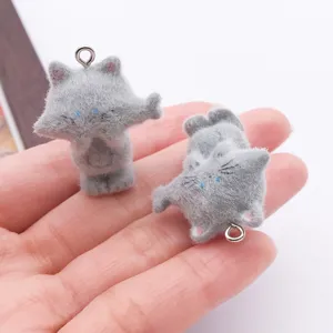 Cute gray flocked resin cat charm close-up, fuzzy texture mini keychain pendant detail.