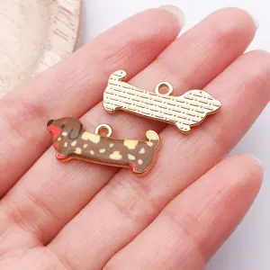 Close-up detail of cute sausage dog metal pendant charms, enamel diy pet jewelry accessories.