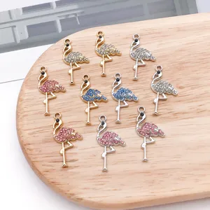 Close-up of sparkling rhinestone flamingo charms, perfect for DIY jewelry making and crafting.