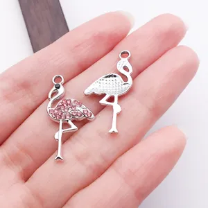 Close-up detail of rhinestone flamingo metal charms for DIY jewelry making, earrings, and pendants.