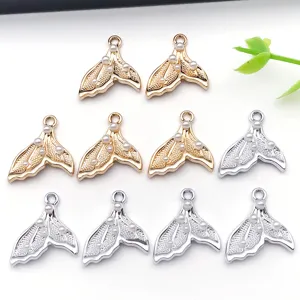 Detail shot of alloy pearl fish tail pendants, DIY jewelry accessories in gold and silver.