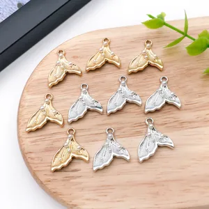 Closeup detail of alloy pearl inlaid fishtail pendant charms for DIY jewelry necklace making.
