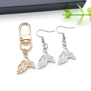 Mermaid tail pearl alloy earrings and keychain jewelry detail shot for DIY accessories.