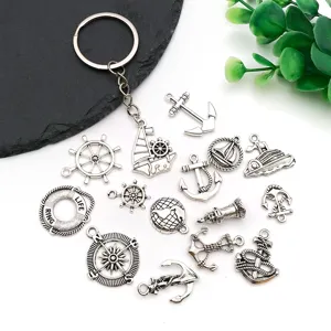 Detail shot of vintage nautical charms set including anchors, steering wheels, and keychain.