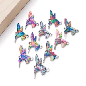 Close-up detail of colorful hummingbird double loop alloy charms for DIY jewelry making.