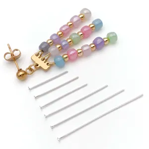 DIY jewelry making findings set with colorful beaded charm and metal headpins for crafts.